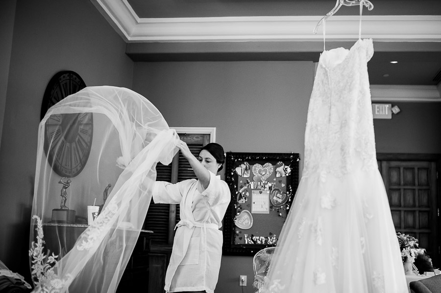 Bride 's veil moments before hanging with the dress