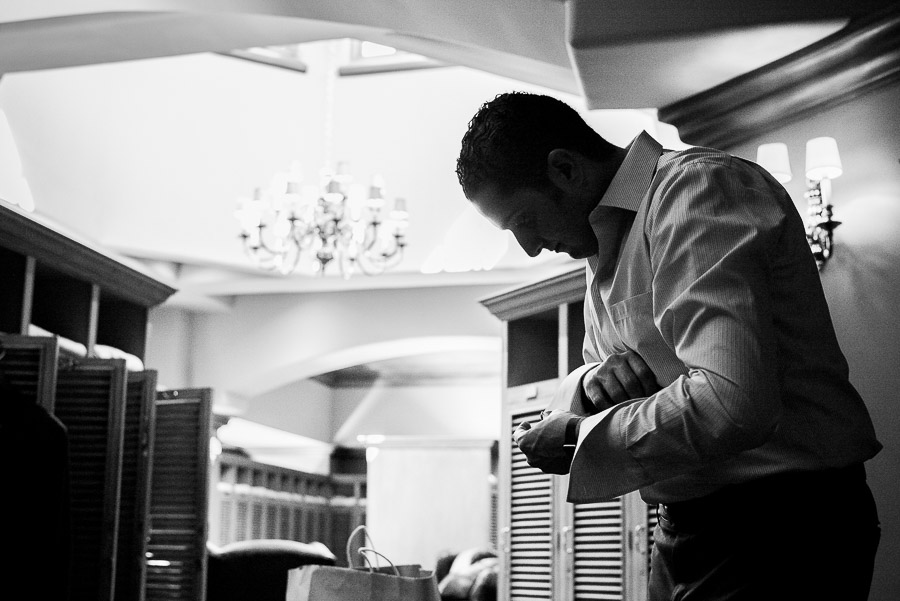 Groom getting ready in mens changing room Dominion Country Club Wedding