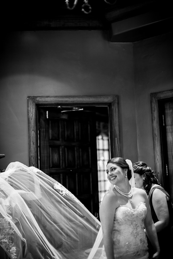 Bride looks back at friends out of frame at Dominion Country Club Wedding