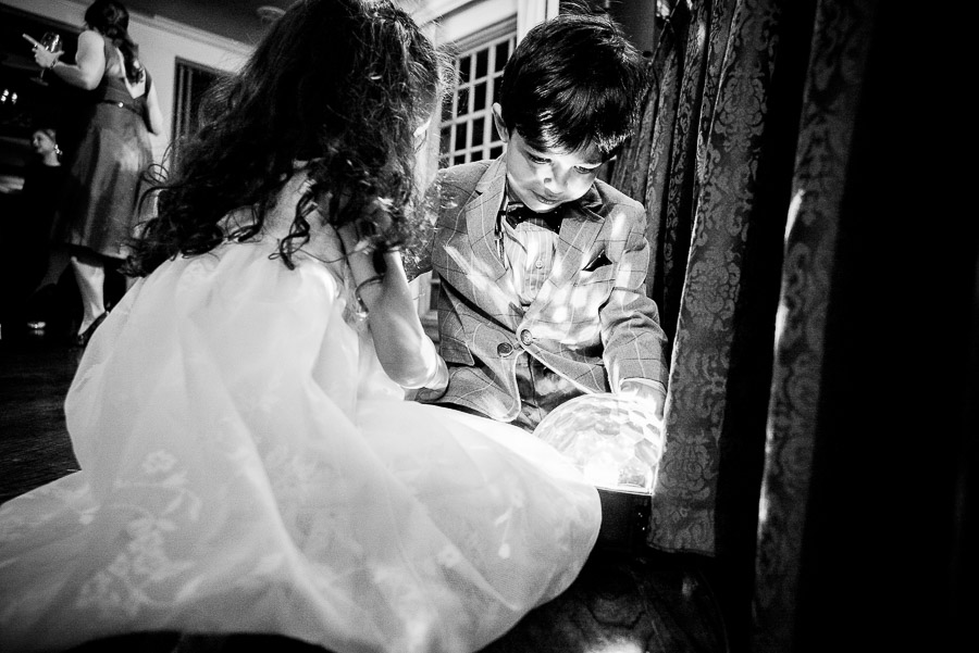 Kids playing with DJ's light at wedding reception