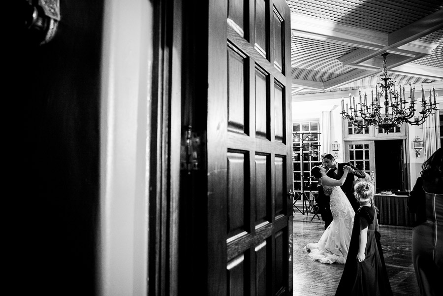 Wed couple dancing as flower girl looks at Dominion Country Club Wedding reception