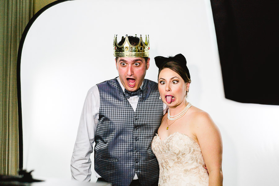 Couple pulling funny faces at photo booth Dominion Country Club Wedding