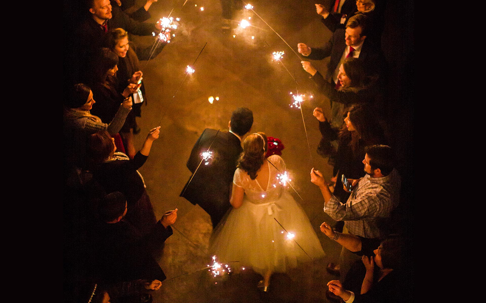 Couple depart with sparklers phootgraphed looking down at Rio-Plaza, San Antonio, Texas