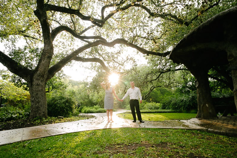 Landa Library Engagement Photos-standing under a tree canopy