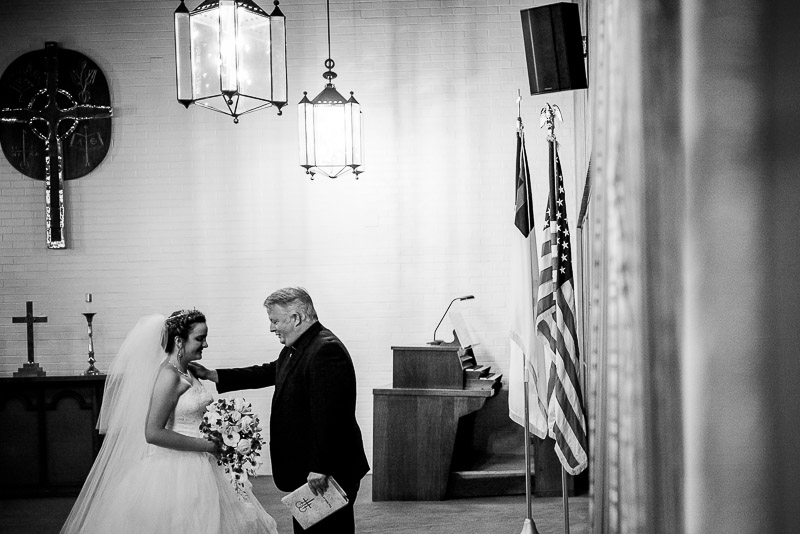 Priest has a quiet prayer with bride at Margarite B. Parker Chapel wedding