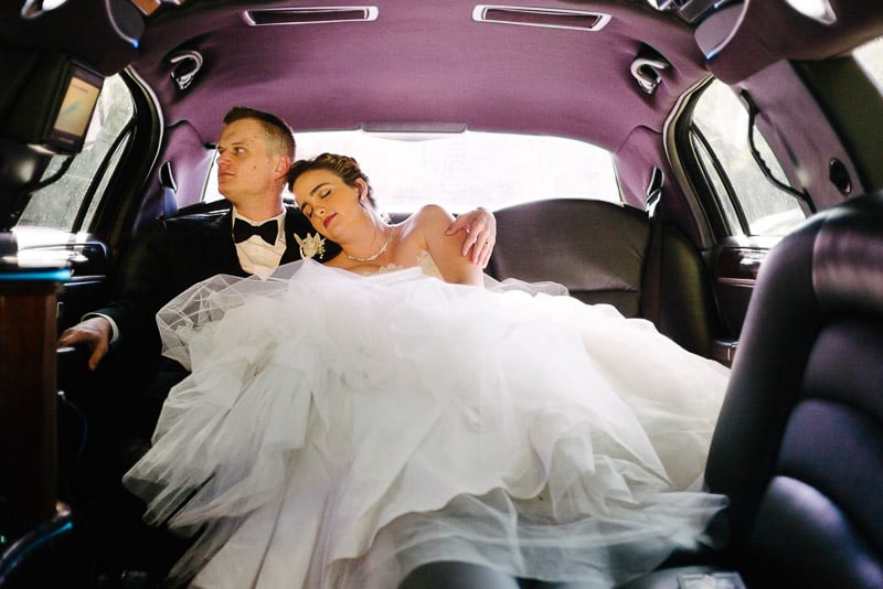 Couple cuddle in limo whilst waiting to depart Margarite B. Parker Chapel, San Antonio, Texas