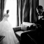 WPJA award winning image - Wedded couple arrive in hotel room brides looks out of window