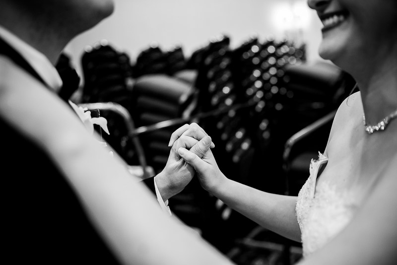 Hands held as couple practise first dance in storage room The Westin Riverwalk, San Antonio, Texas