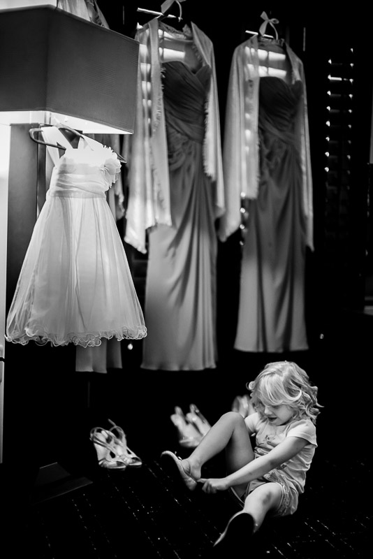 Flowergirl places shoes on feet at The Valencia