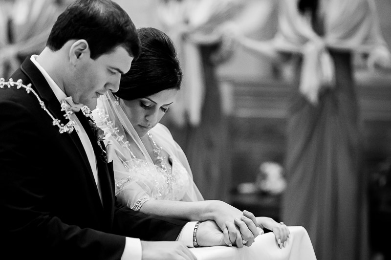 Wedded couple, Adrian and Melissa deep in prayer at San Fernando Cathedral, San Antonio, Texas