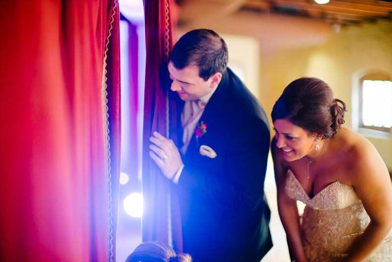Couple peek through the curtains moments before their wedding reception entrance at Pearl Brewery, San Antonio, Texas