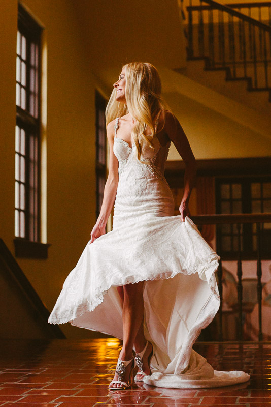 Bridal portrait of beautiful bride low angle twirling dress shot at library Houston Texas