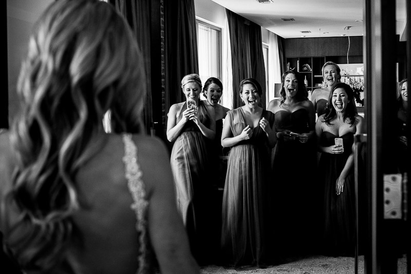Bridesmaids see bride for first time as door opens at JW Marriott Presidential Suite Houston Texas