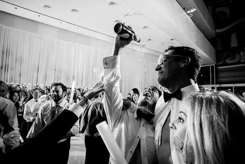 Groomsmen pours beer in grooms face as bride gasps at Houston Wedding-Hobby Center Wedding Houston-Philip Thomas