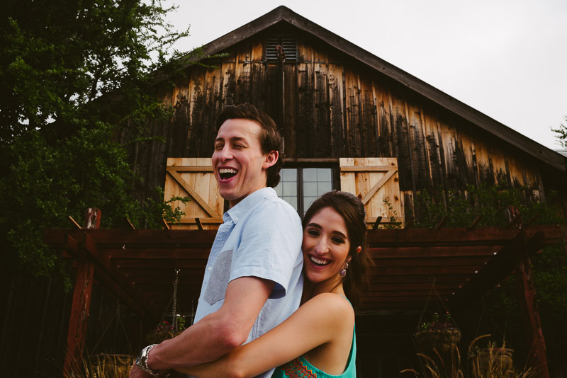 Engaged couple stand in front of historic building in Gruene Texas Engagement Session-Philip Thomas