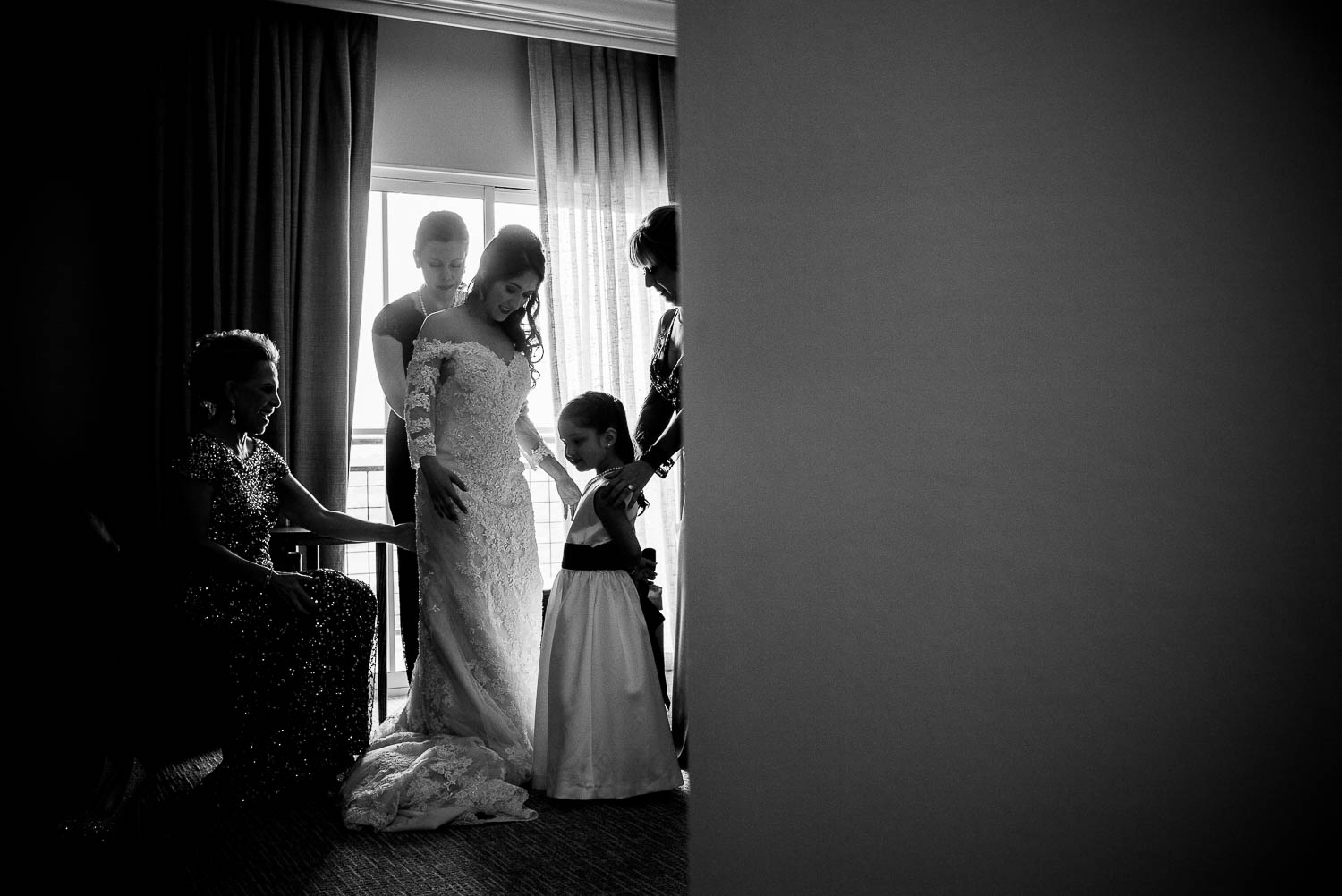 Bride receives help getting ready with her wedding dress at la-cantera-resort-wedding-photographer-philip-thomas