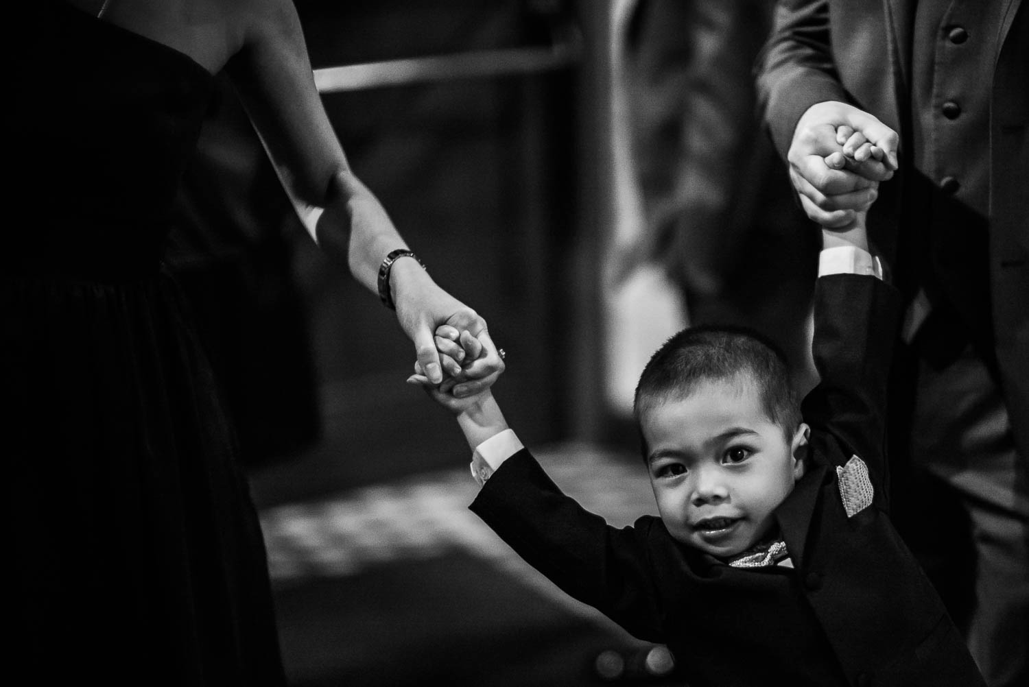 Little boy holds parents hands at wedding reception pearl-stable-wedding-wedding-photographer-philip-thomas-035