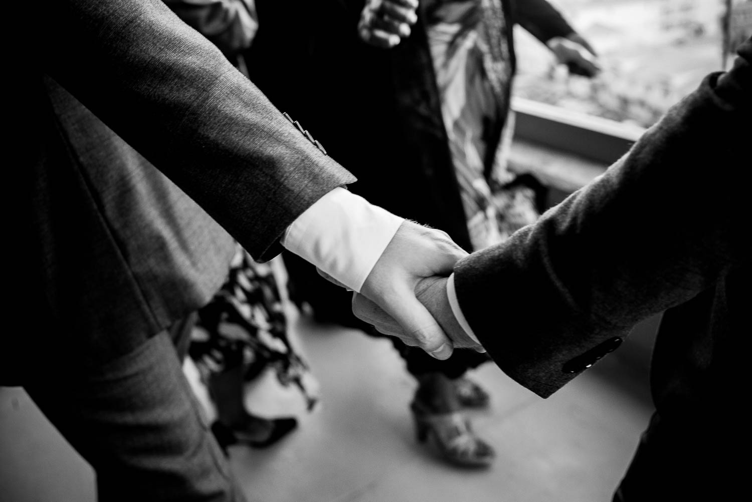 Two grooms holding hands through reception at Marina Del Rey California Wedding