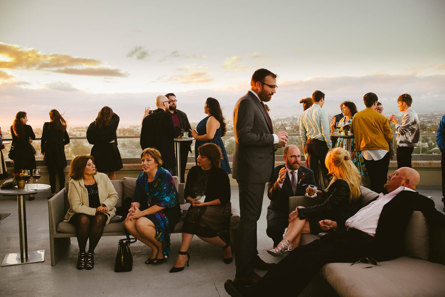 Cocktail hour at a wedding reception shows grooms chatting to guests at same-sex-wedding-marina-del-rey-marriott-los-angeles-leica-wedding-photographer-philip-thomas