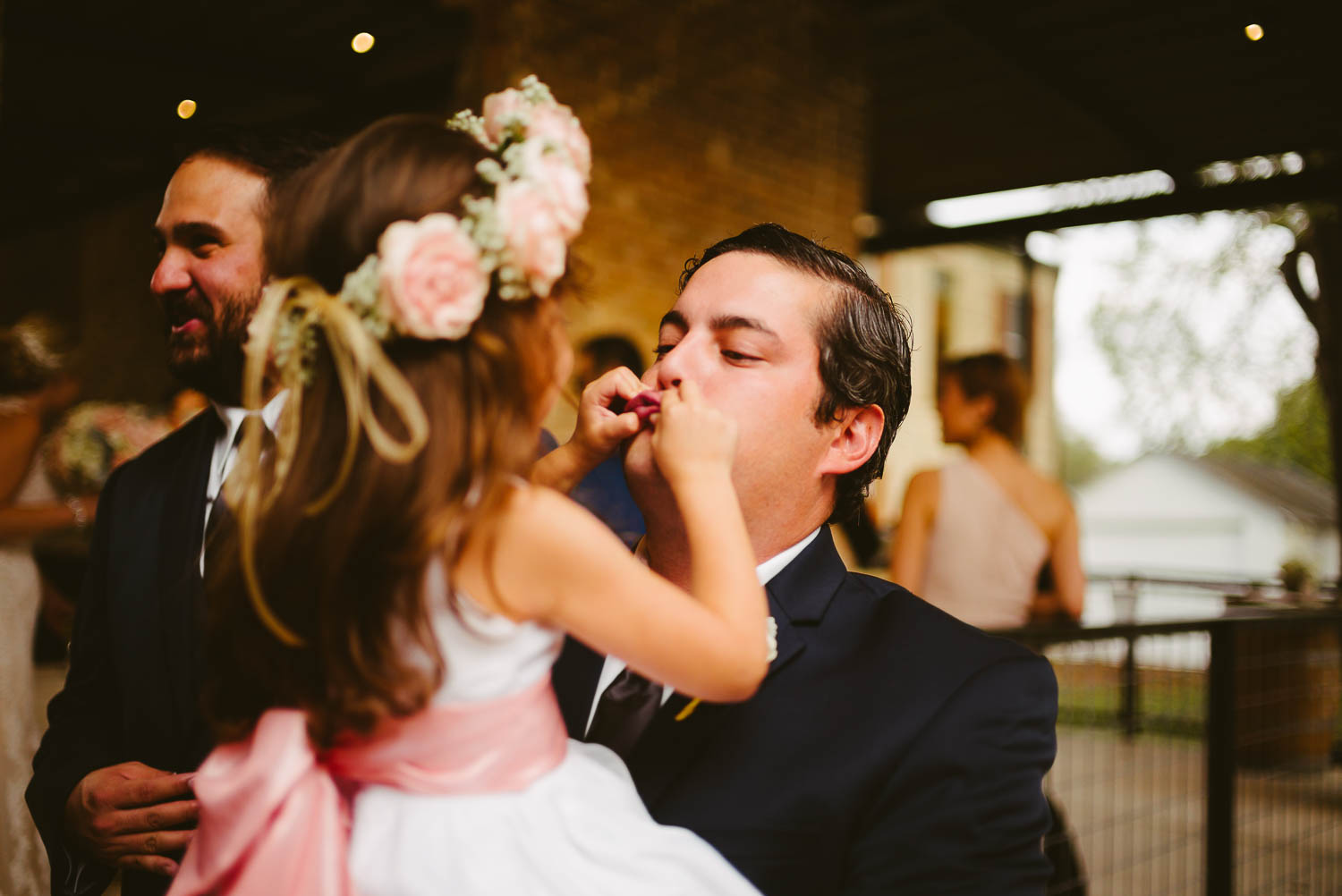 Flower girls holds father lips shut tight for fun during wedding festivities at ingenhuett-on-high-wedding_leslie_omar-leica-wedding-photographer-philip-thomas-029