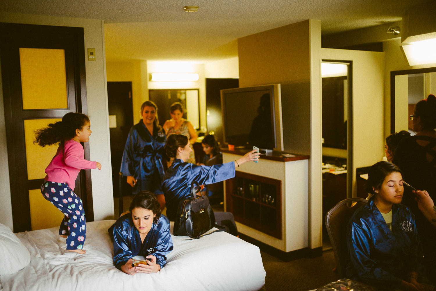 flower girls jumps on bed at Hyatt Place hotel, san antonio