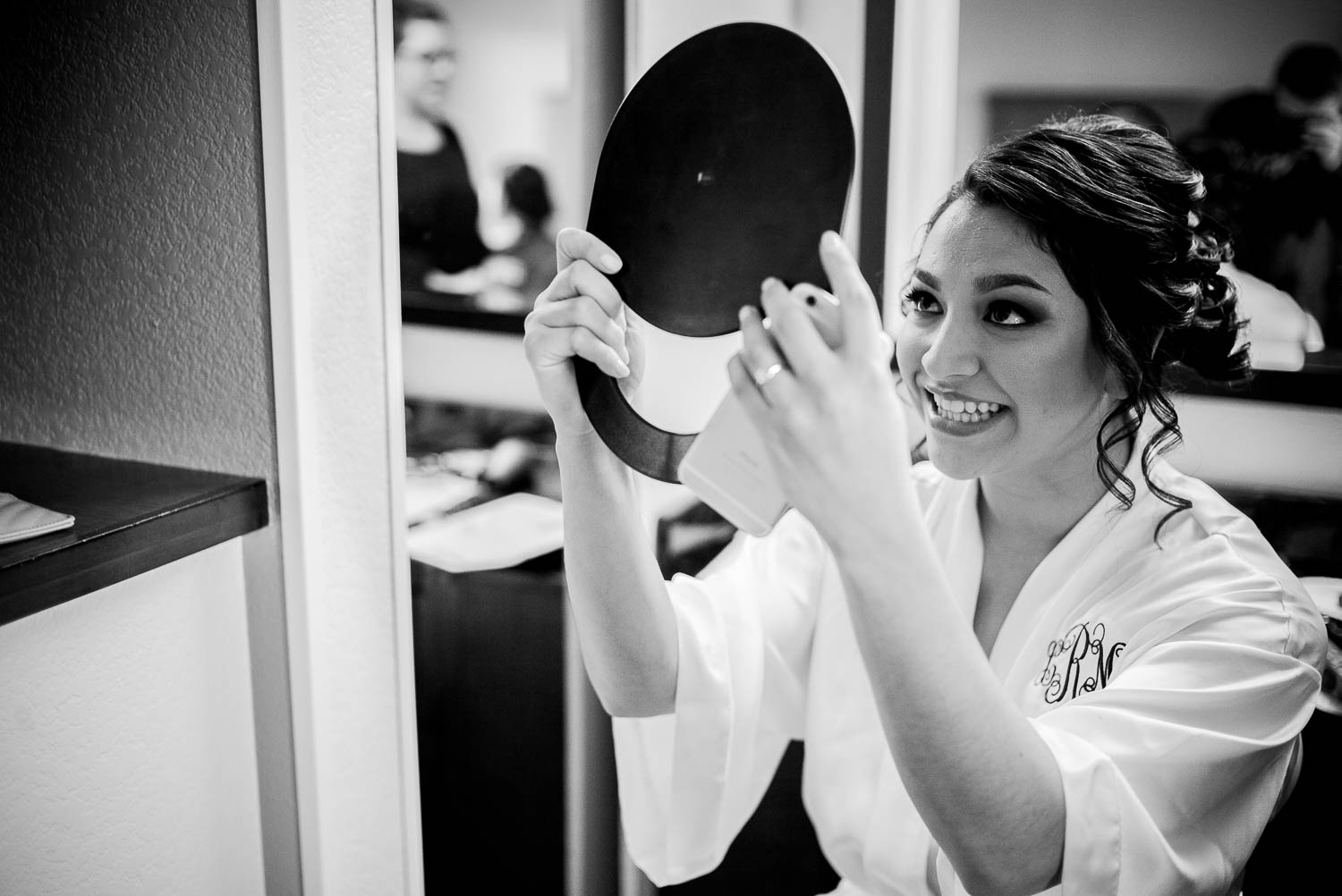 bride checks herself in mirror at Hyatt Place hotel san antonio texas