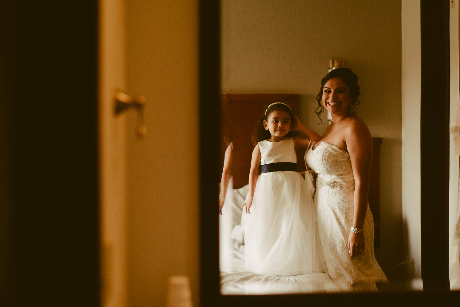 Bride and daughter are captured looking in the mirror at Hyatt Place
