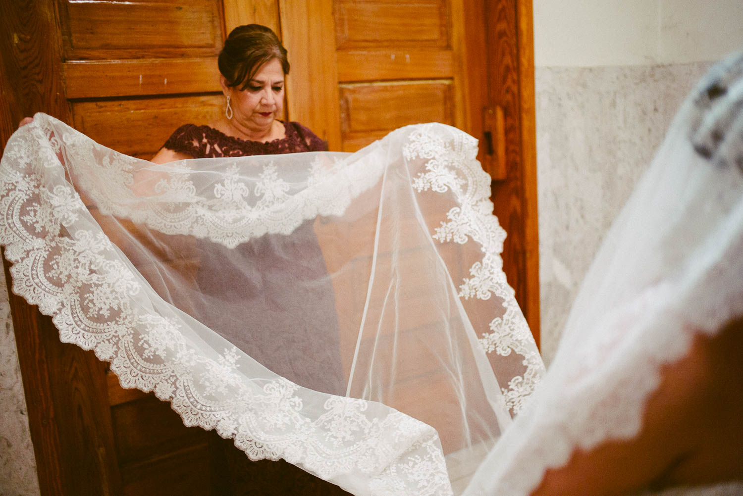Mother of the straightens out brides dress at immaculate-heart-of-mary-church-philip-thomas-photography