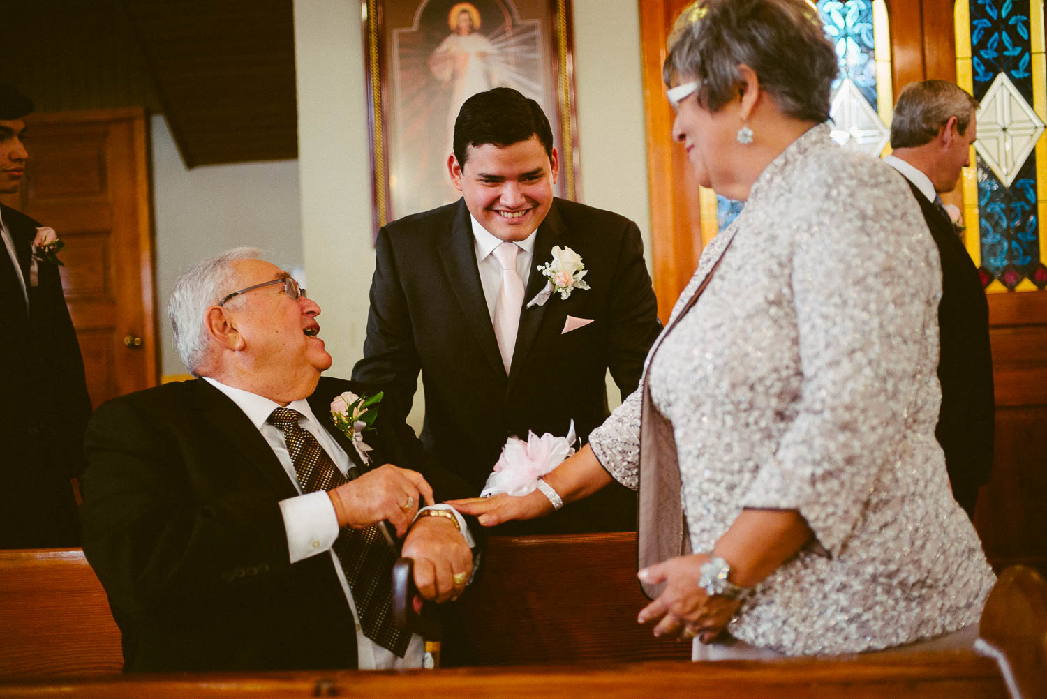 Jokes are shared with family members and groom at immaculate-heart-of-mary-church-philip-thomas-photography