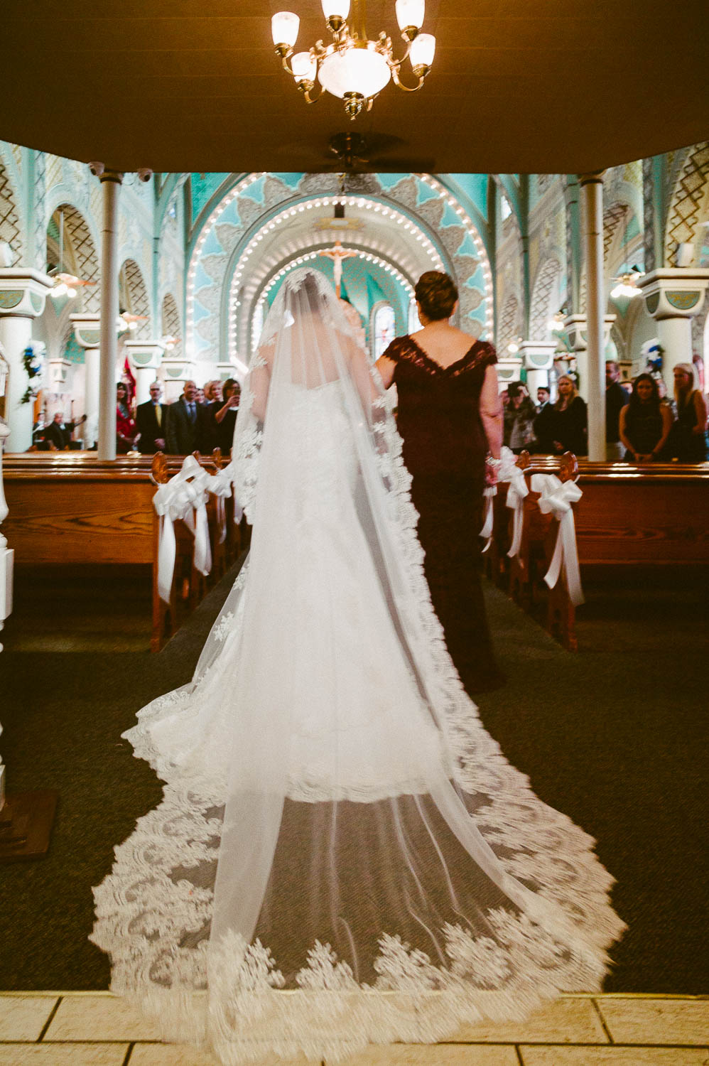 Bride and mother walk down the aisle at immaculate-heart-of-mary-church-philip-thomas-photography