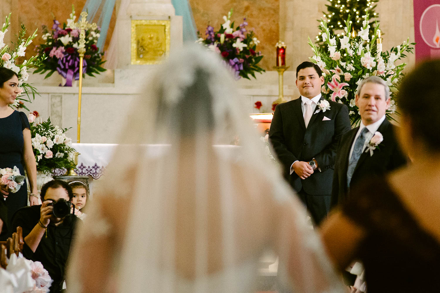 Groom sees his wife to be walking down the aisle at immaculate-heart-of-mary-church-san antonio texas philip-thomas-photography
