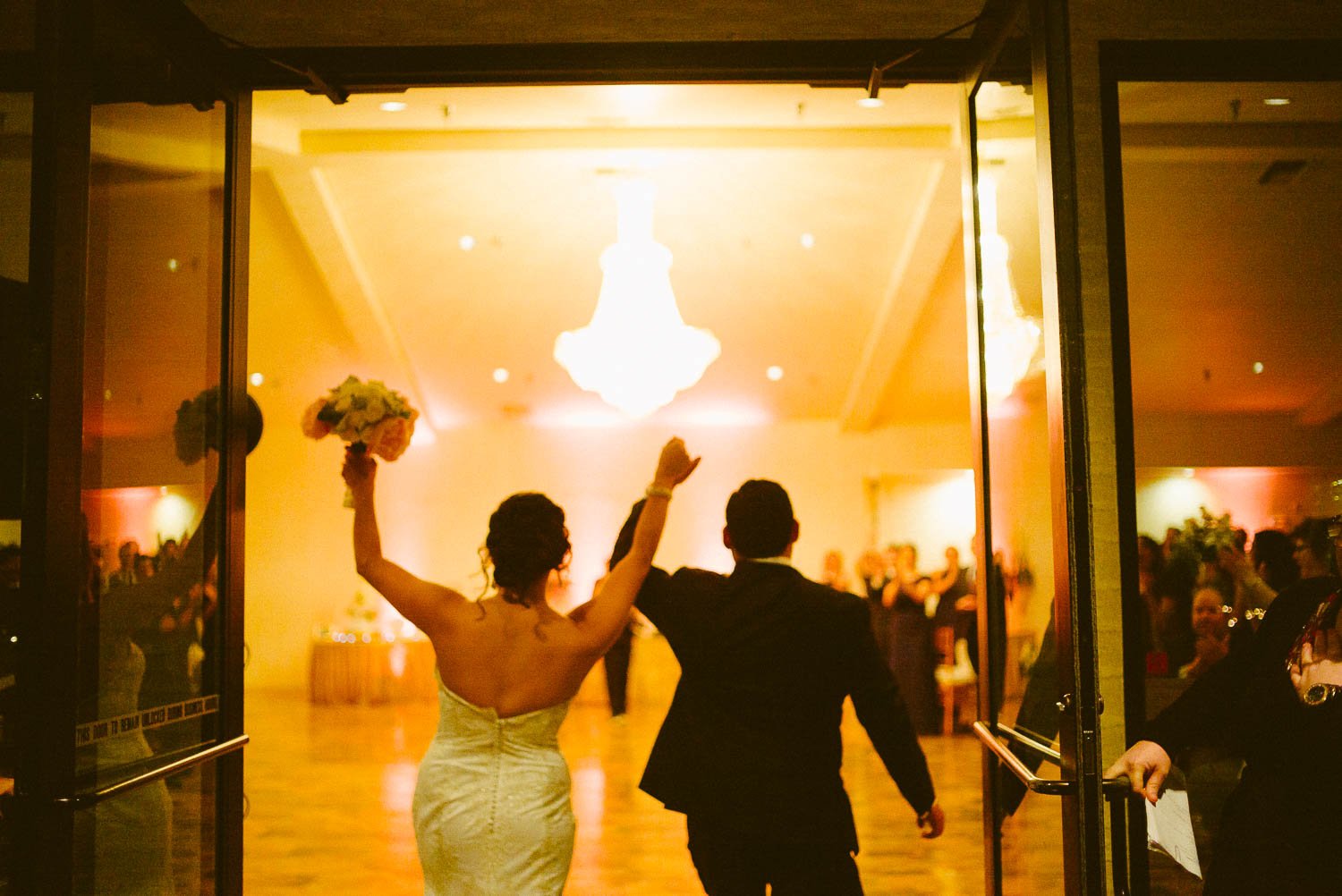 Wedded couple enter reception to cheers at granberry-hills-weddings-philip-thomas-photography