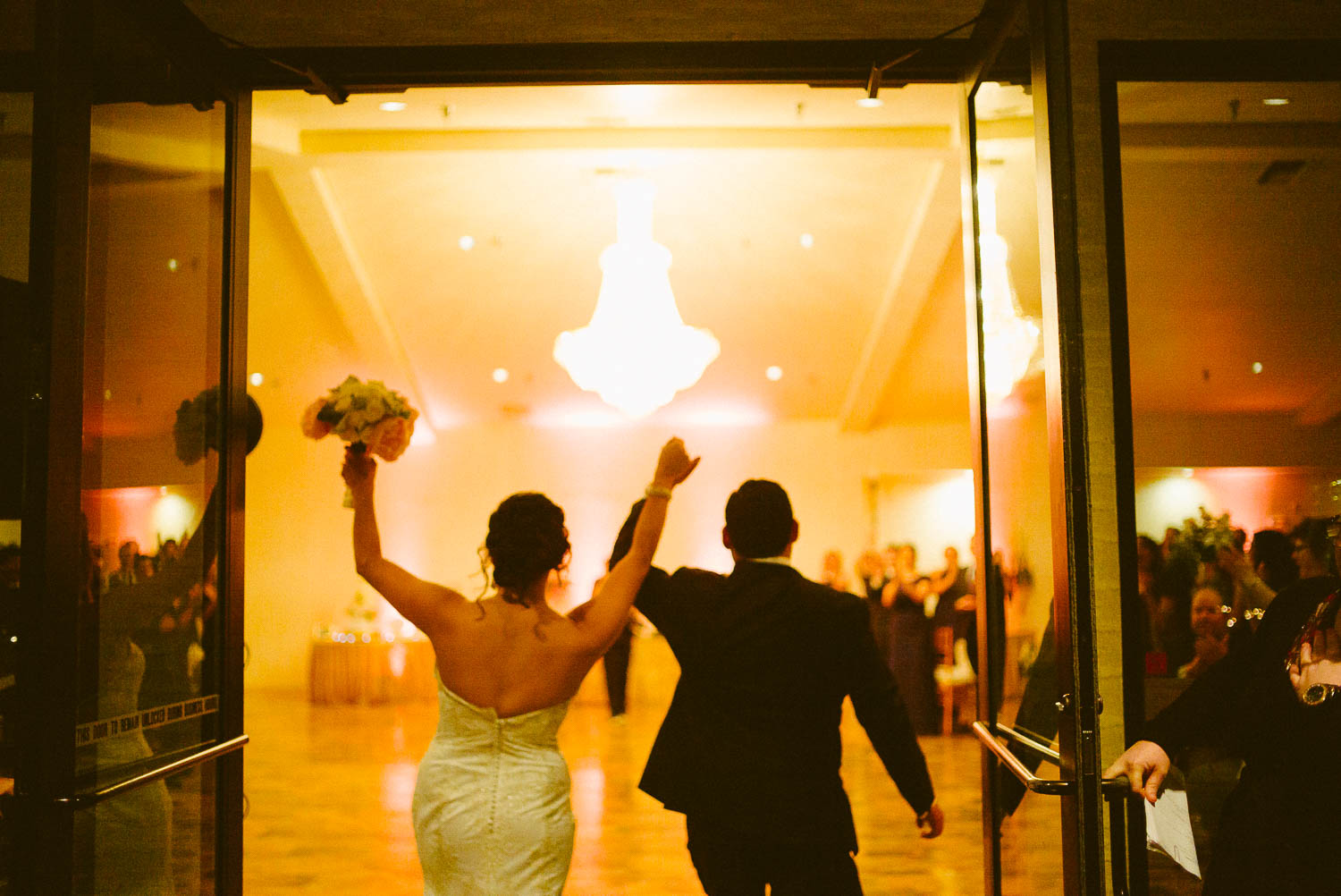 Wedded couple enter reception to cheers at granberry-hills-weddings-philip-thomas-photography