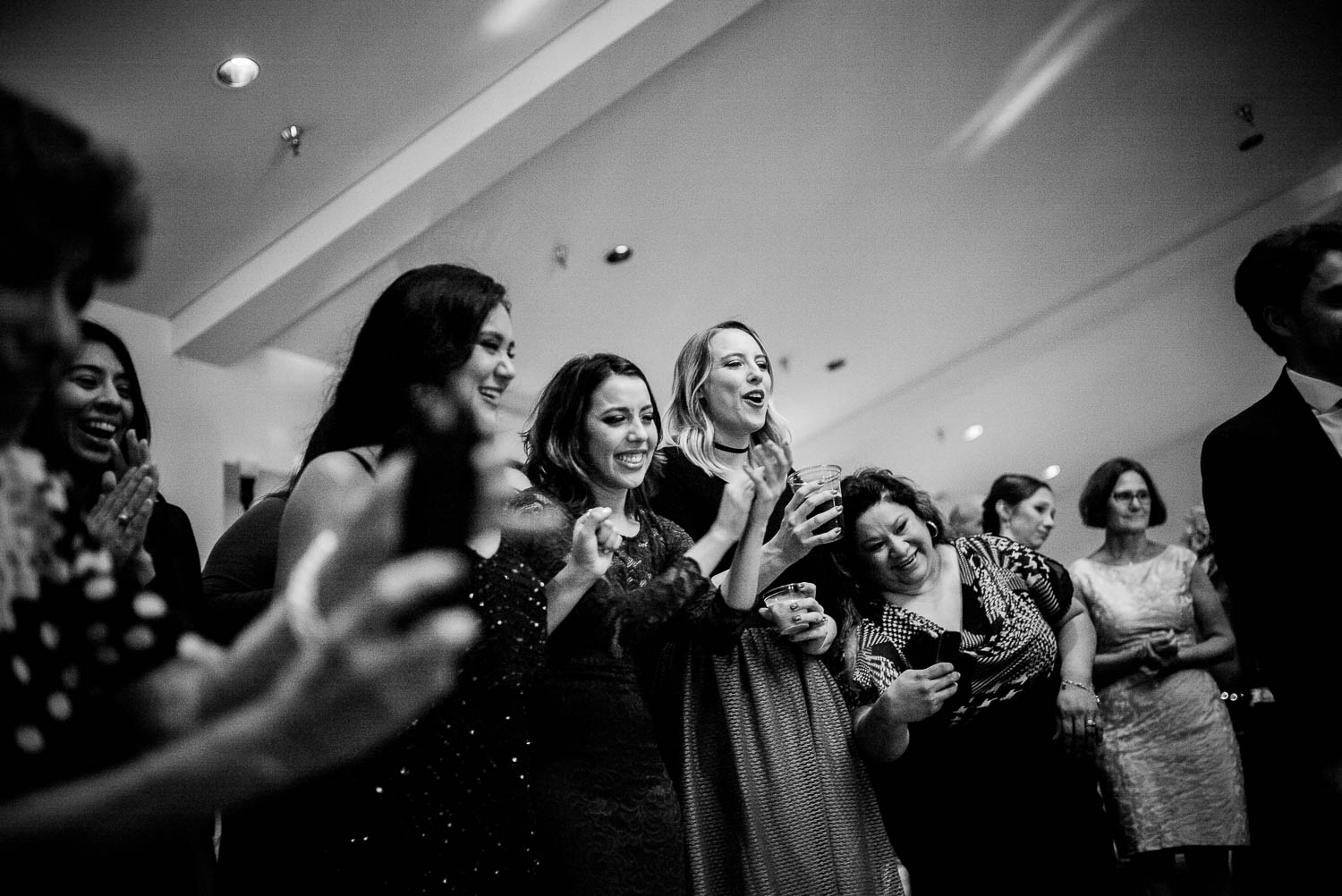 Wedding guests reactions as groom picks garter at a wedding reception Granberry Hills Wedding, Philip Thomas Photography