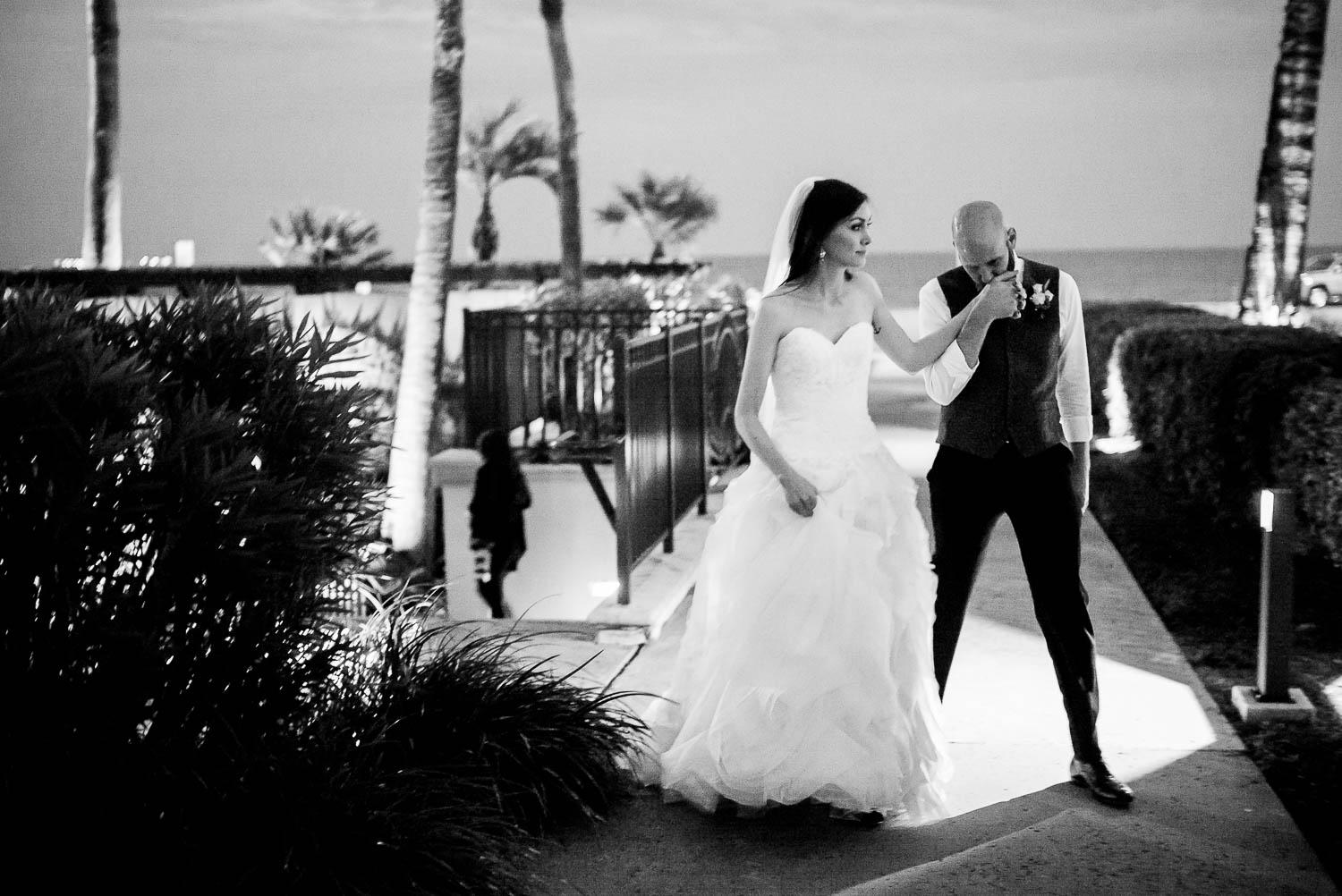 After wedding ceremony groom kisses brides hand at hotel-galvez-wedding-philip-thomas-photography-025