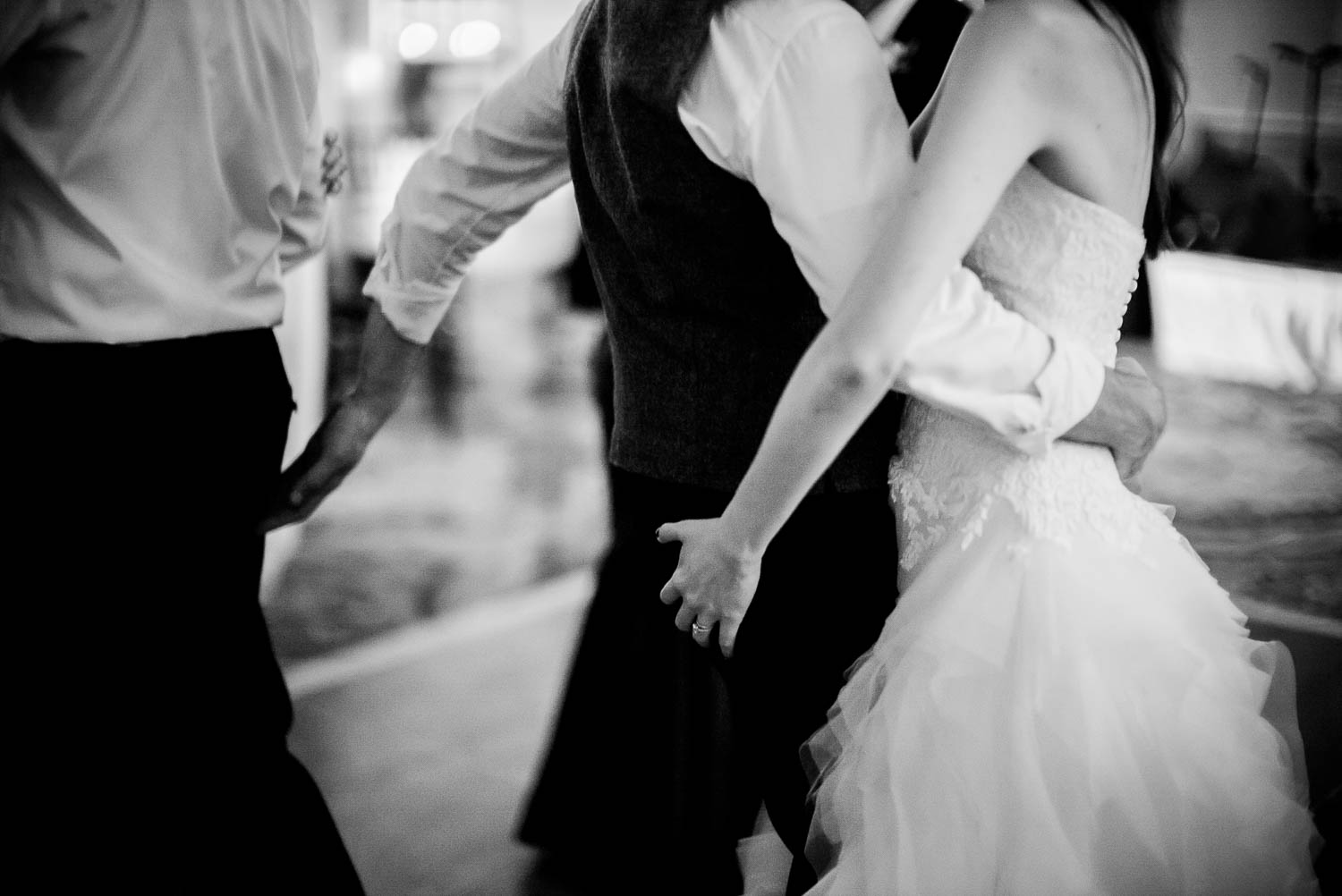 A decisive moments captured as groom pats a friends behind and bride does same to groom in a playful momentshotel-galvez-wedding-philip-thomas-photography-042