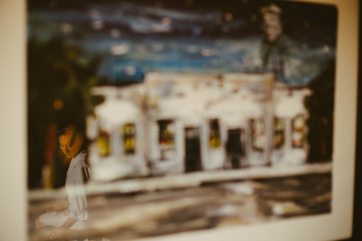 Makeup is applied to bride in reflection painting glass frame of The Alamo, San Antonio, Texas at la-cantera-resort-wedding-philip-thomas-photography-001