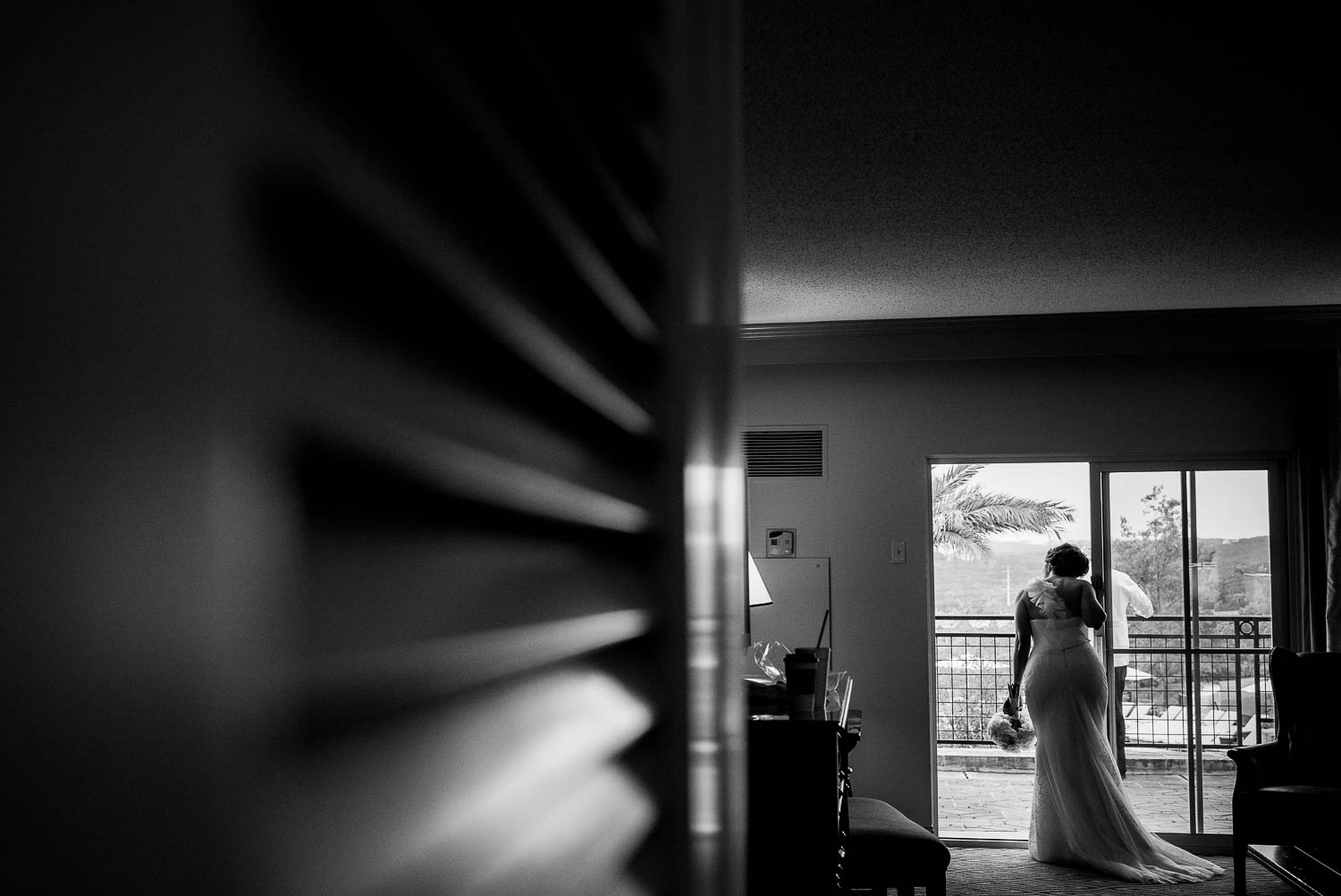 Bride peeks out to look at the ceremony as she waits at la-cantera-resort-wedding-philip-thomas-photography-008