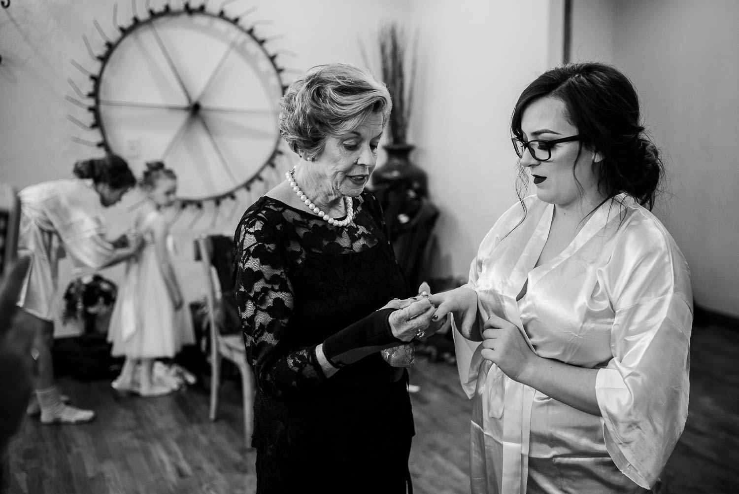 Grandmother of the bride places an heirloom ring on the brides fingers at The Springs Boerne-Leica Wedding photographer-Philip Thomas