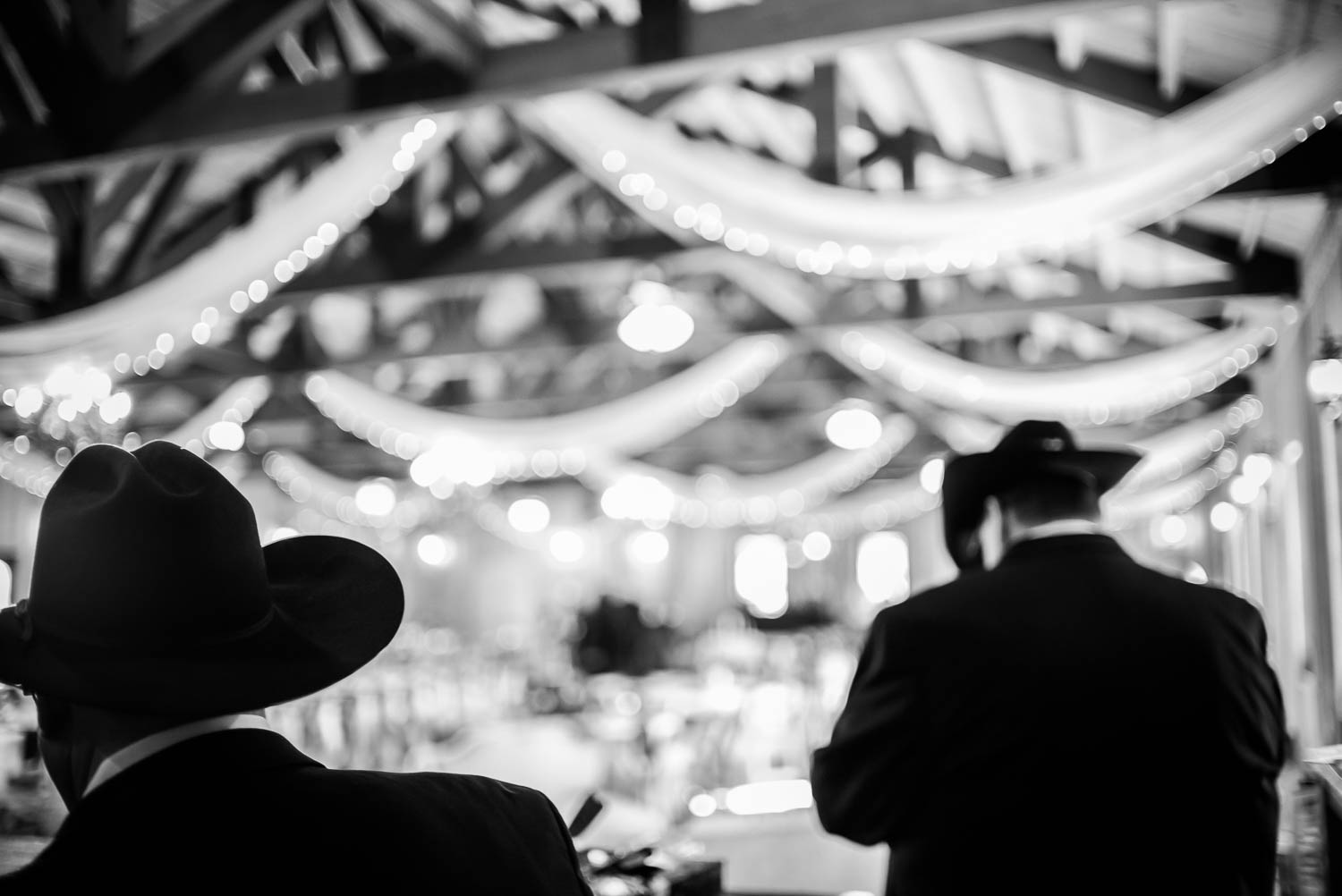 Cowboys hats black against bright background pre ceremony at The Springs Boerne-Leica Wedding photographer-Philip Thomas