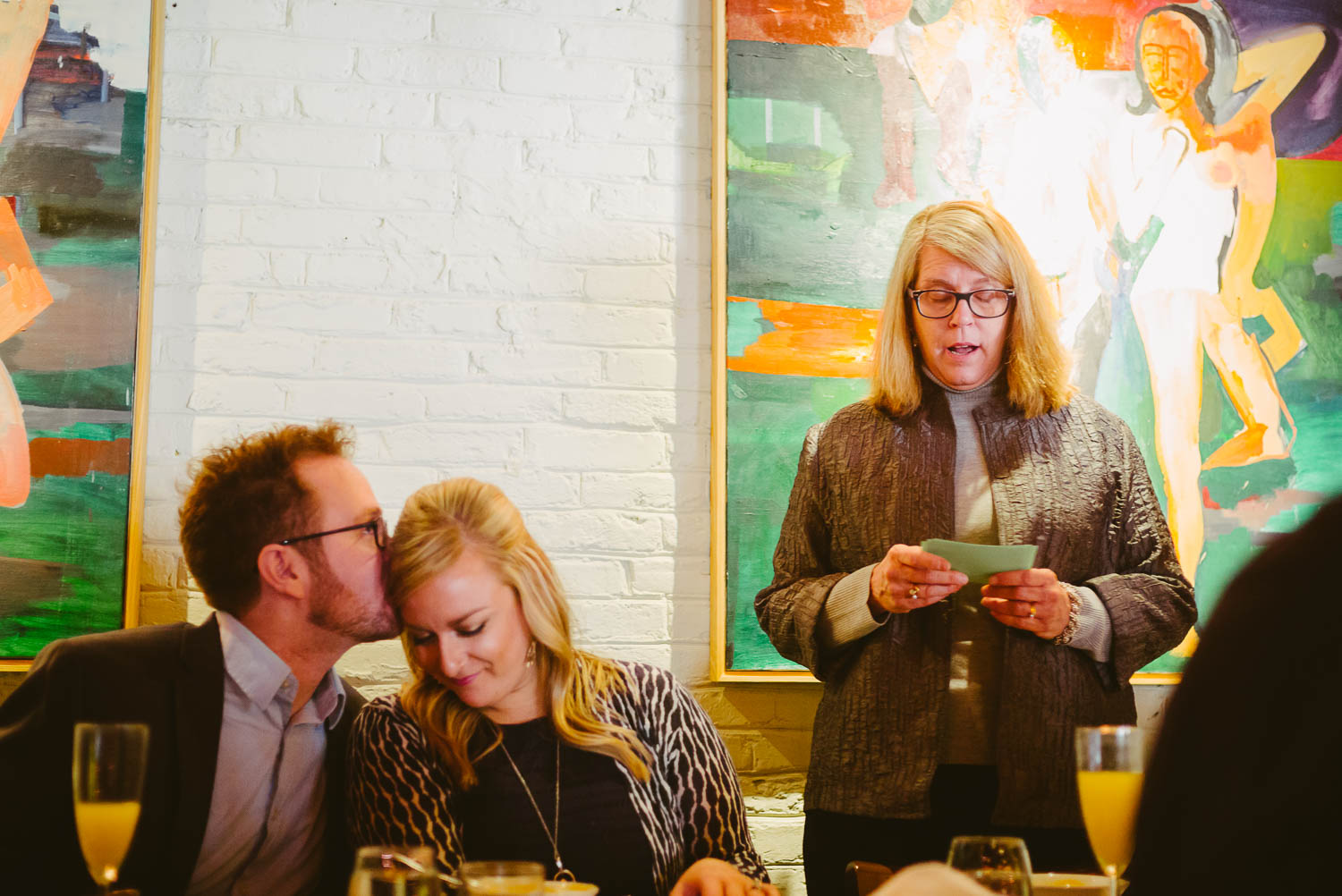 During a rehearsal dinner the groom kisses the bride as her mother speech