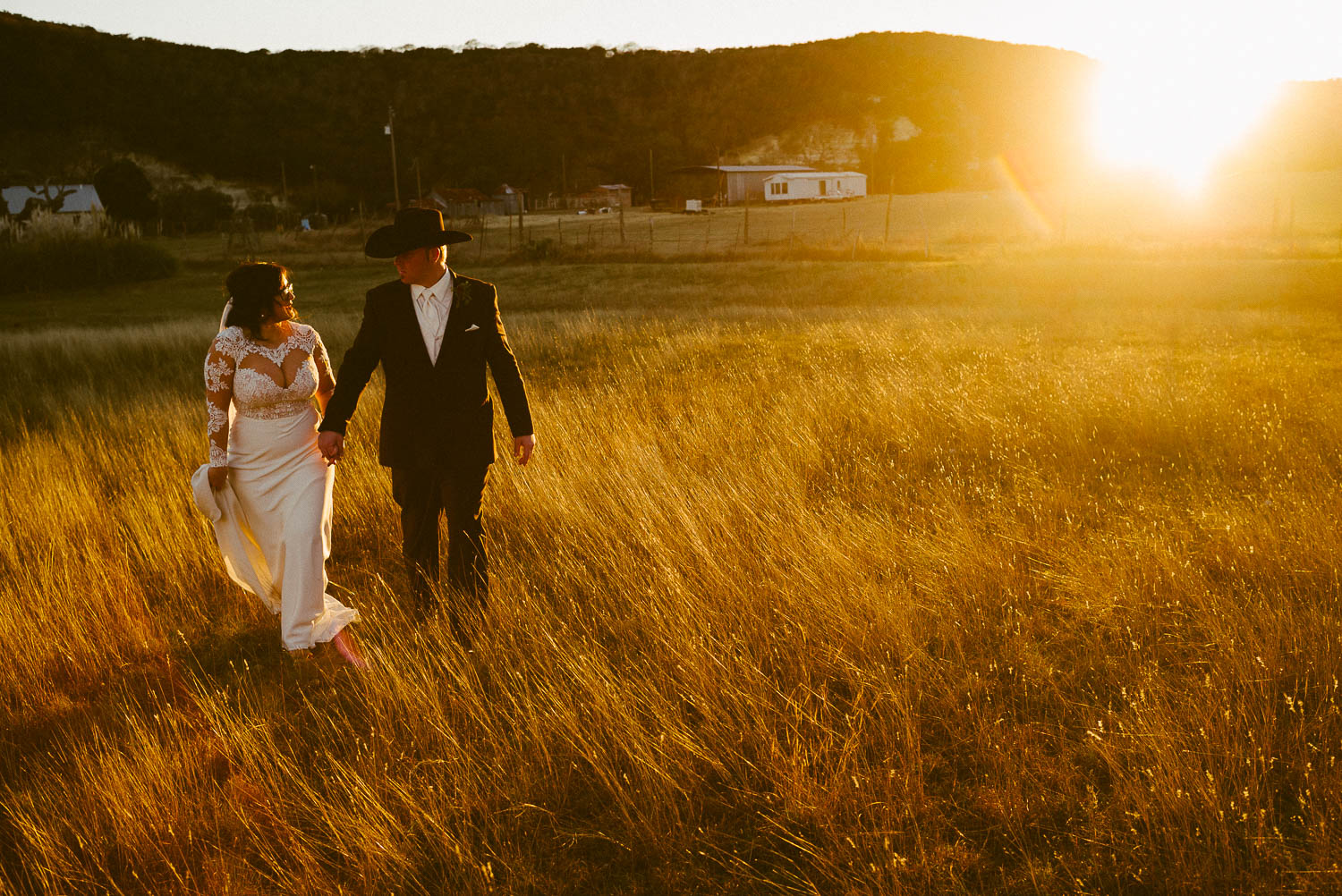 Couple walk before sunset at The Springs Wedding in Boerne, Texas.