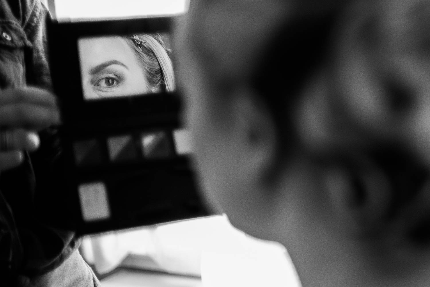 The bride checks her makeup in a hotel room prior to getting married in Silver Spring Maryland DC