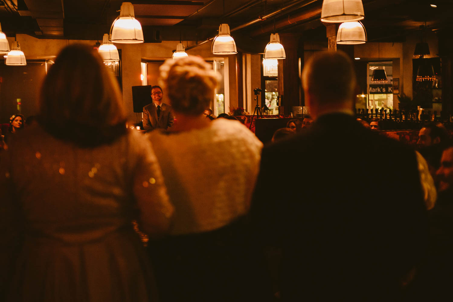 Rear view of bride mother and father walking down the aisle at Takoma Park Washington D.C-Leica Wedding photographer-Philip Thomas