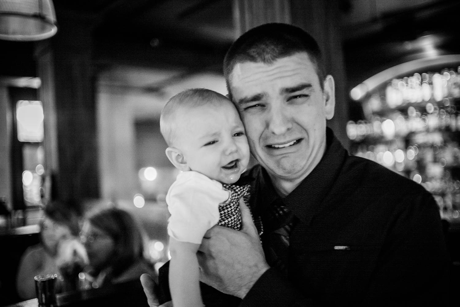 A humorous iages of father and baby son at wedding reception Republic Takoma Park Washington D.C-Leica Wedding photographer-Philip Thomas