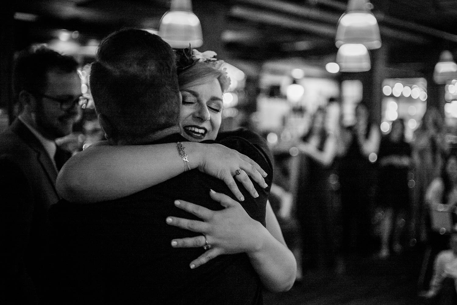 Bride hugs a guest at Republic wedding reception Takoma Park Washington D.C-Leica Wedding photographer-Philip Thomas