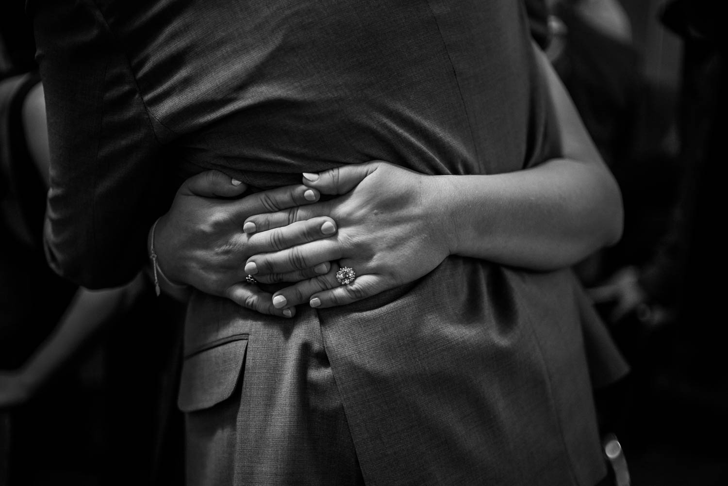 Hands clasped around grooms waist at Republic wedding reception Takoma Park Washington D.C-Leica Wedding photographer-Philip Thomas