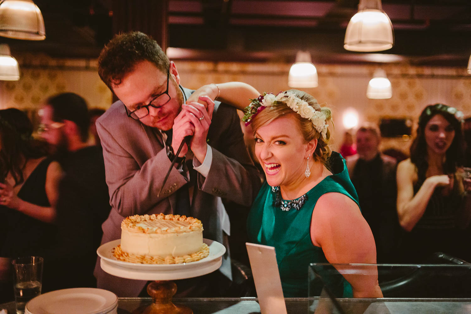 Hamming up for the camera wedding couple cut the cake at wedding reception Republic Takoma Park Washington D.C-Leica Wedding photographer-Philip Thomas