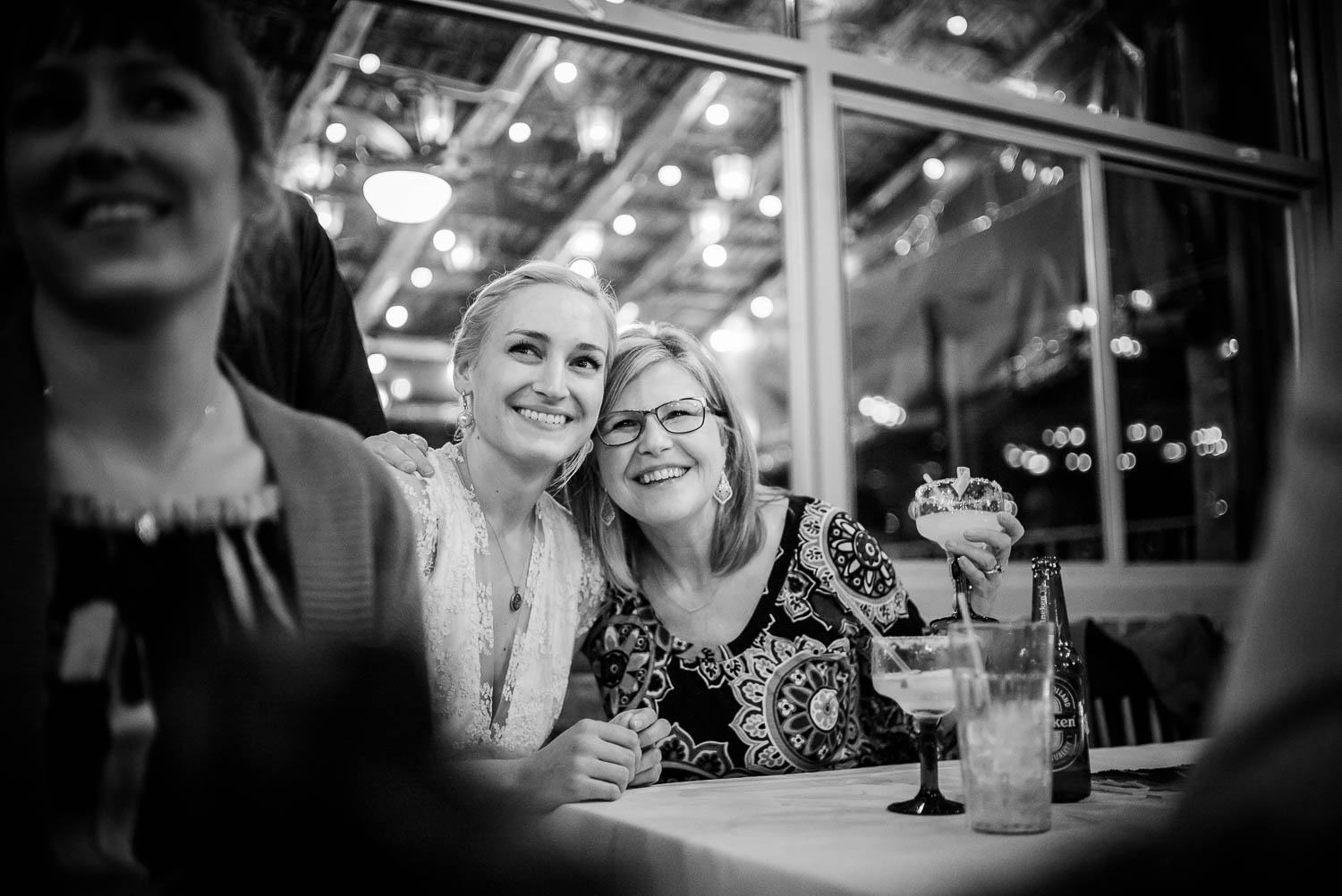 Mother and bride react to wedding rehearsal dinner in El Tiempo restaurant, Houston, Texas.