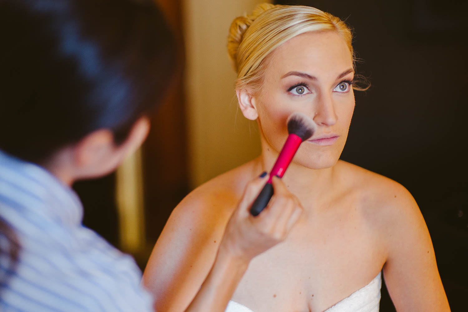 Bride getting ready with makeup brush Hyatt Regency, Houston, Texas.